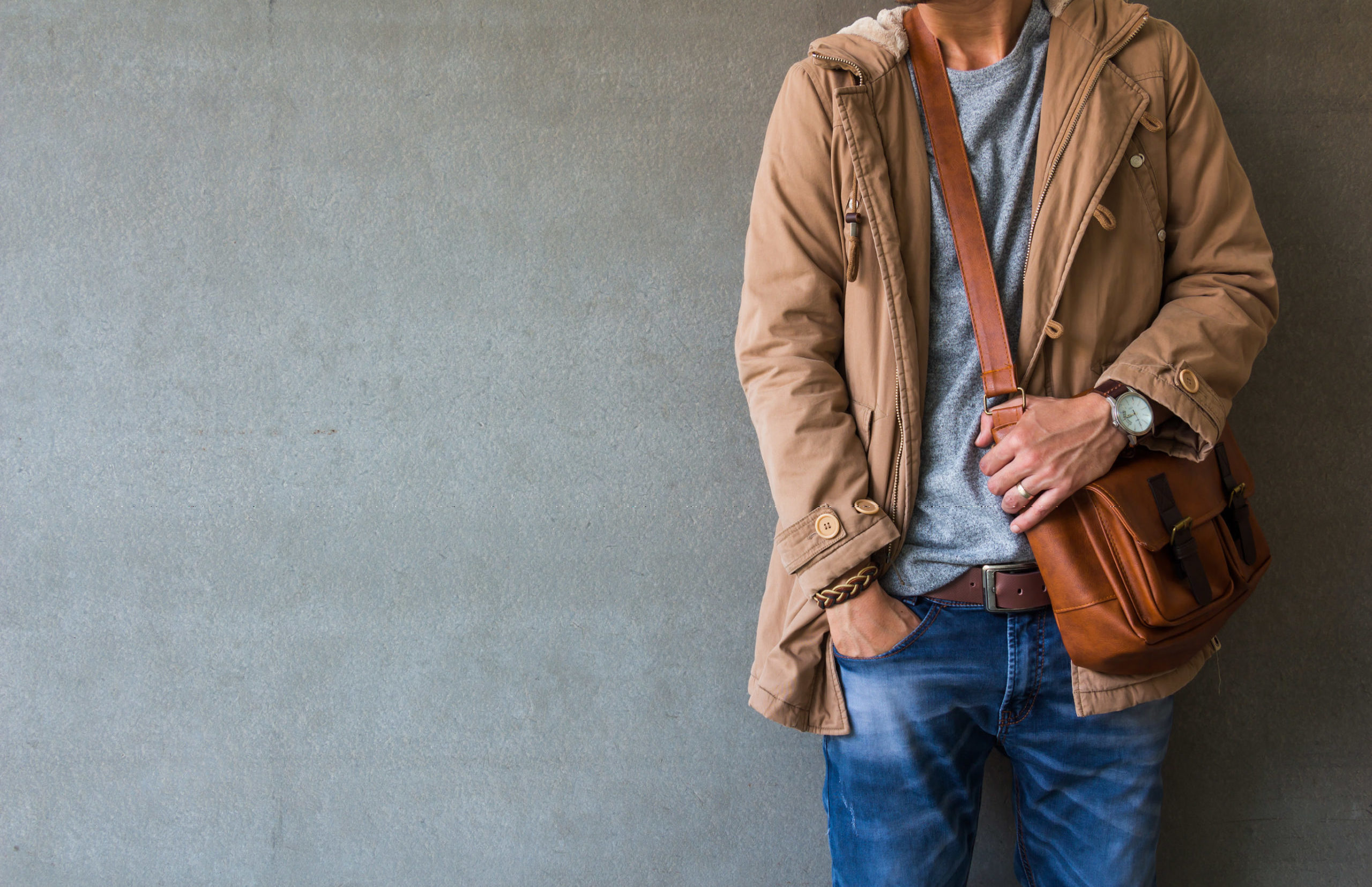 Men's casual outfits standing over gray grunge background with space, beauty and fashion concept