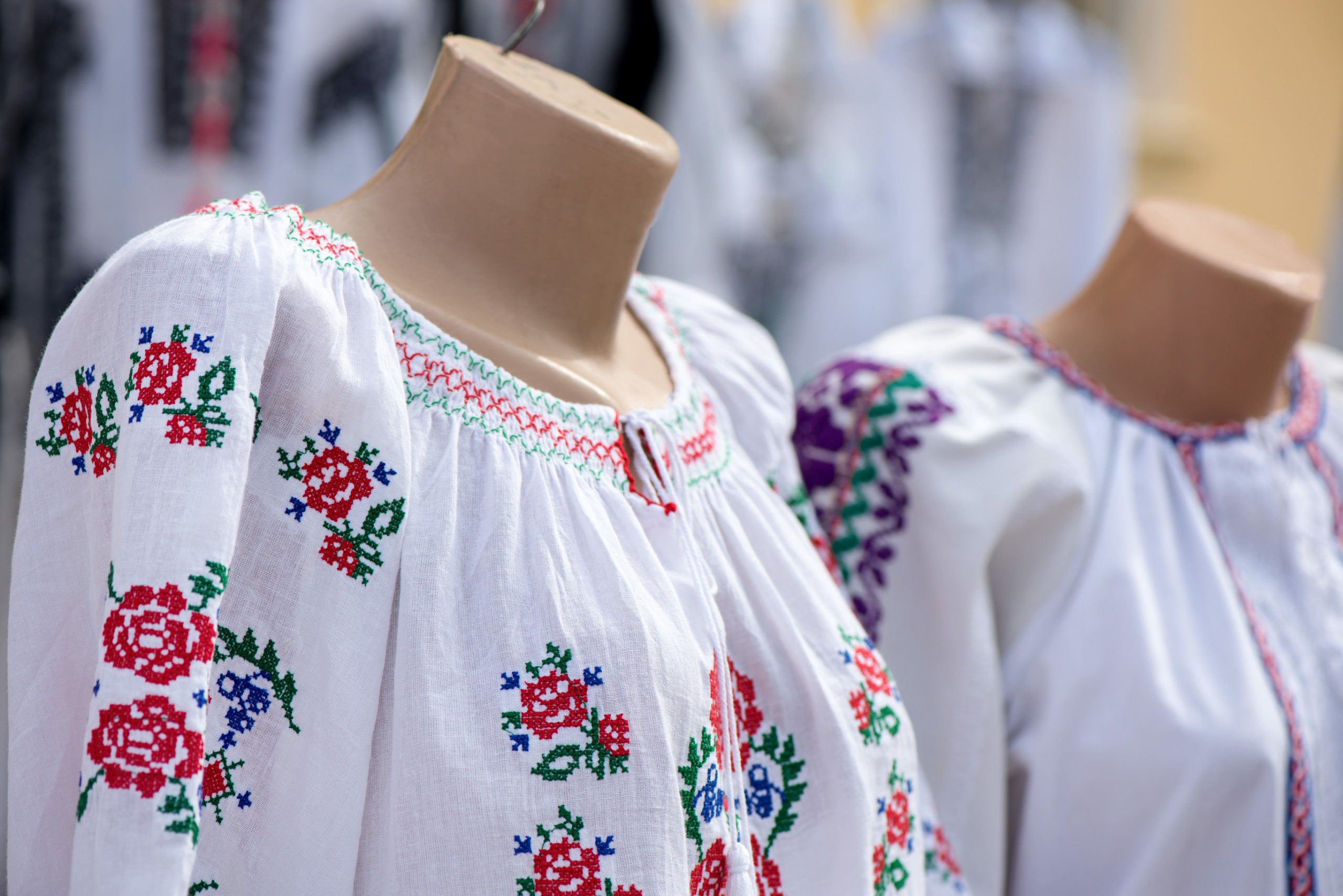 Traditional linen shirt with embroidered flowers and ornaments weared on mannequin at local market at state fair